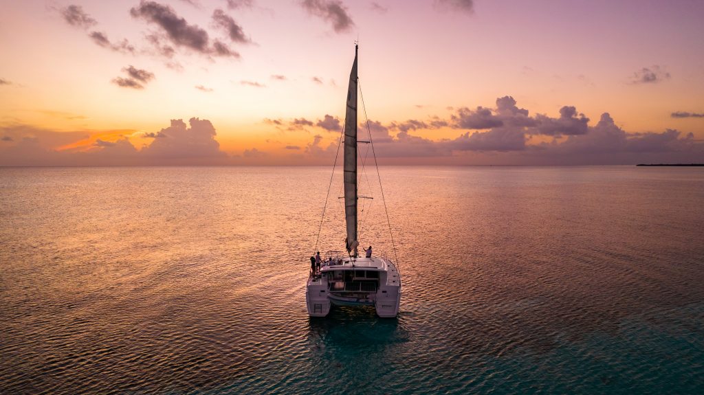 Sailboat silhouetted at sunset