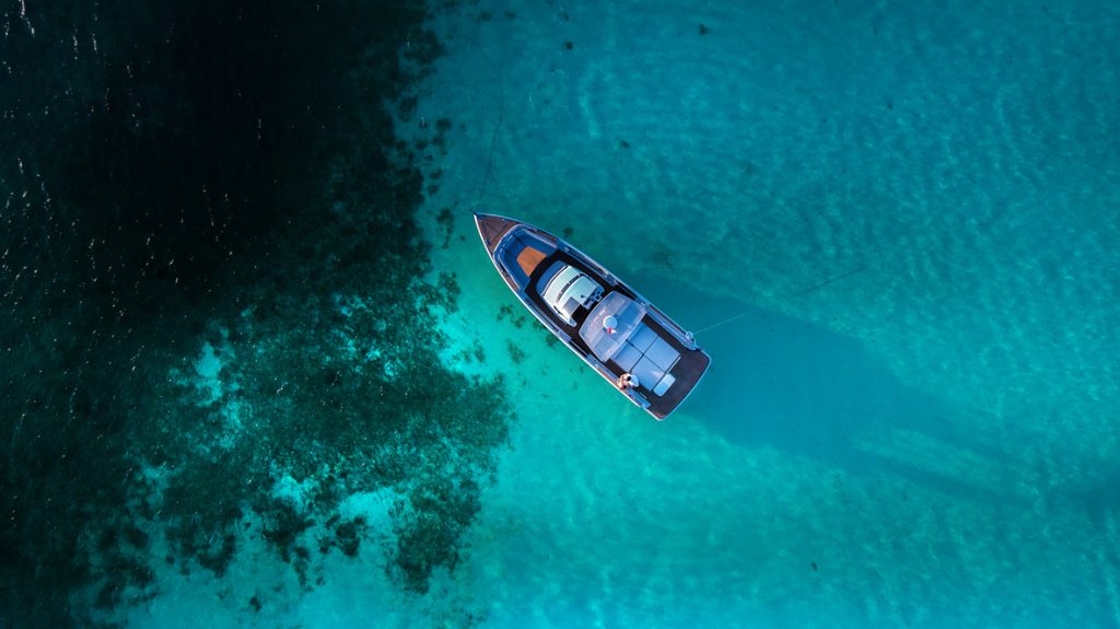 Aerial view of a private boat in deep blue water
