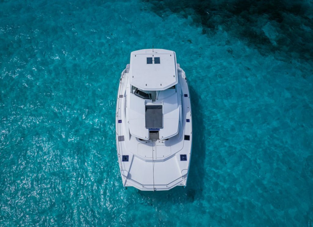 Aerial view of a catamaran over turquoise sea