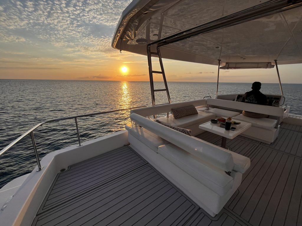 Stern lounge with a sunset view