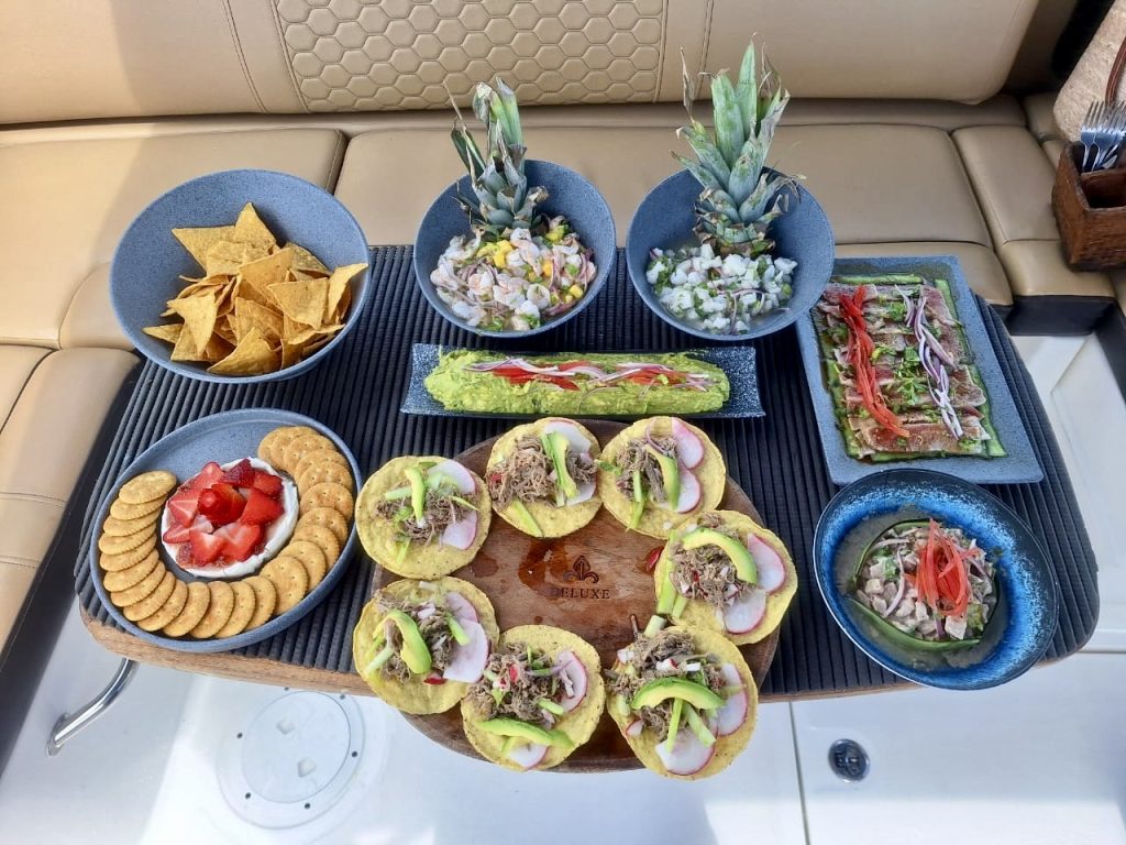 A full lunch spread of tostadas, ceviche and fresh fruit