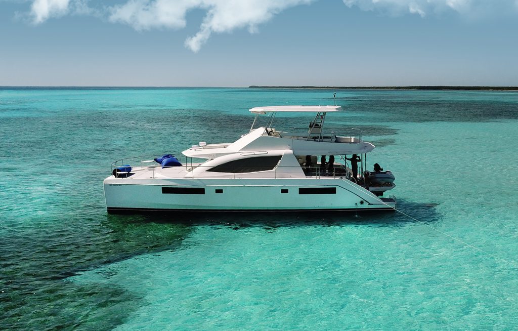 Leopard 51 power catamaran anchored in turquoise water