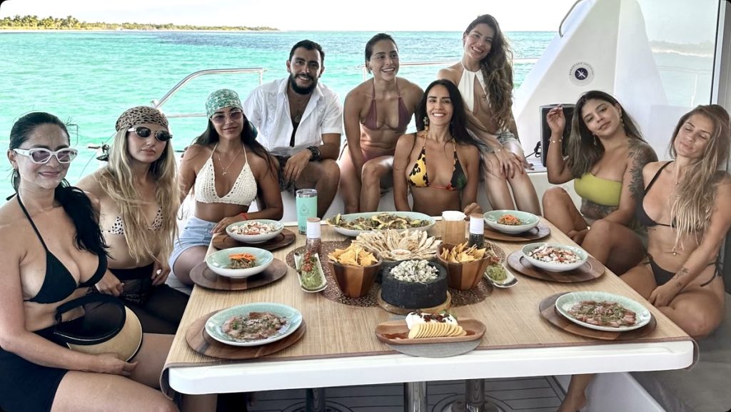 Group sharing lunch around a table on board