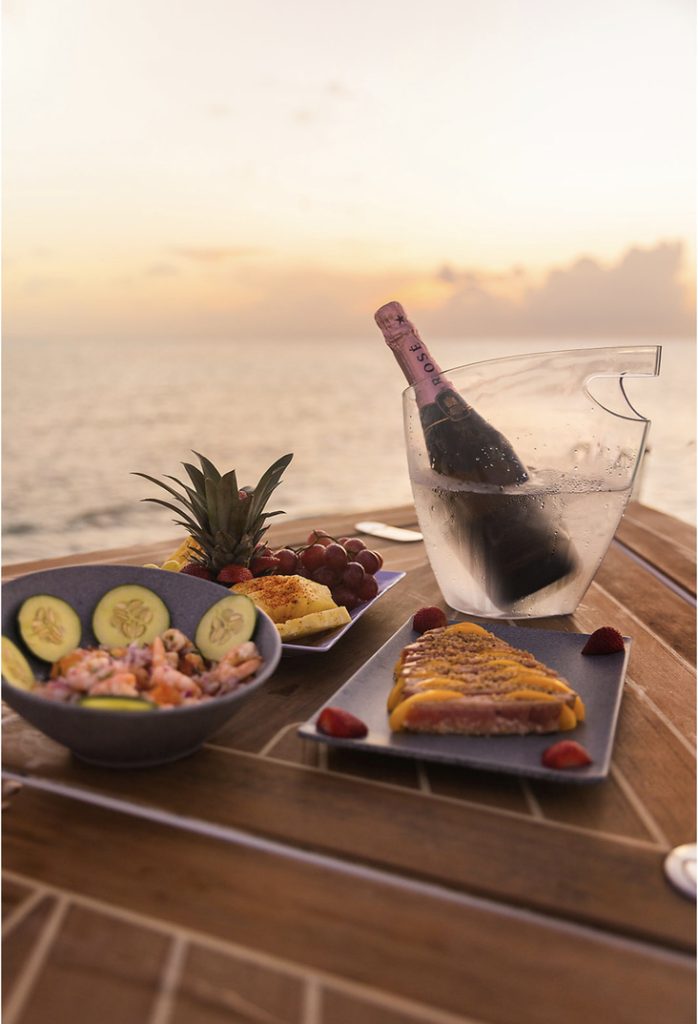 Champagne on ice with fresh fruit on deck