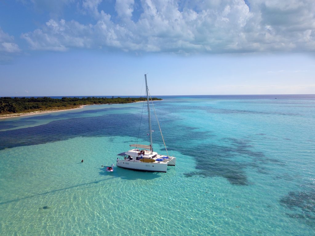 Sailing catamaran anchored in the Cozumel shallows