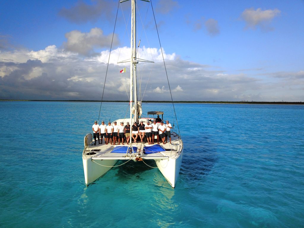 Catamaran sailing in turquoise water with guests