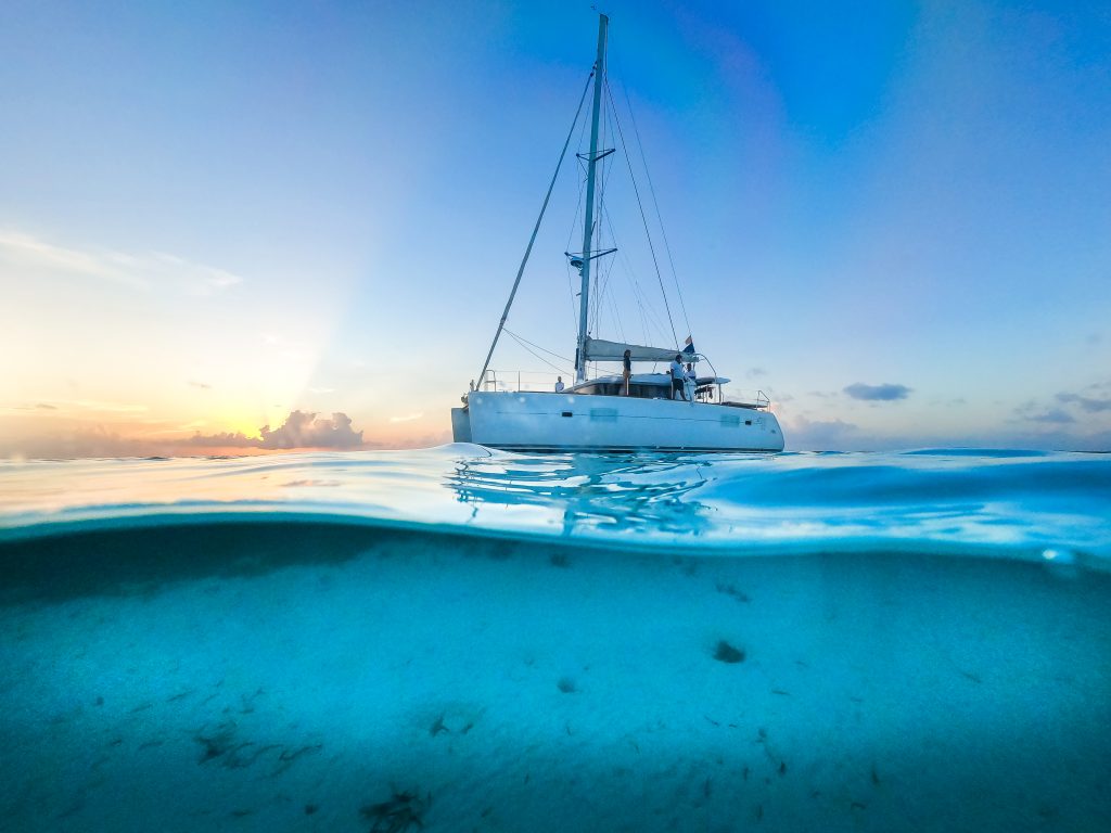 Catamaran seen from half above and half under the water