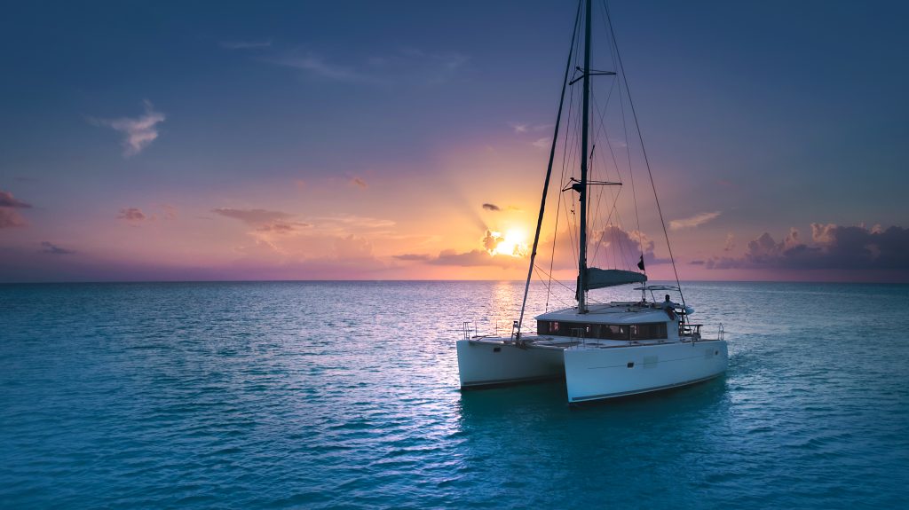 Catamaran silhouetted against the setting sun