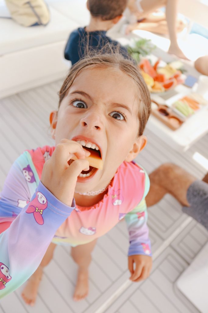 Little guest enjoying fresh fruit on board