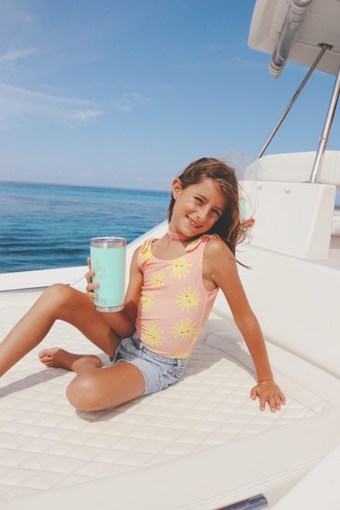 Young guest relaxing on deck with a cold drink