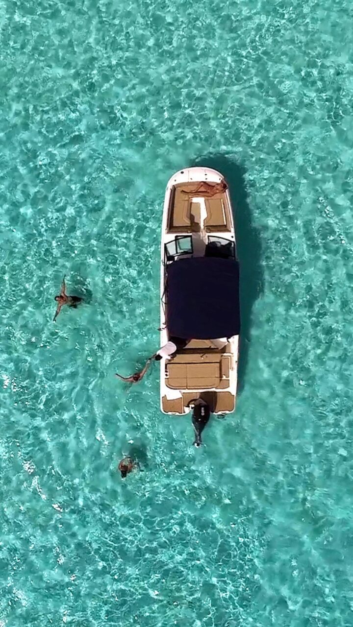 Private boat anchored in the turquoise water of El Cielo