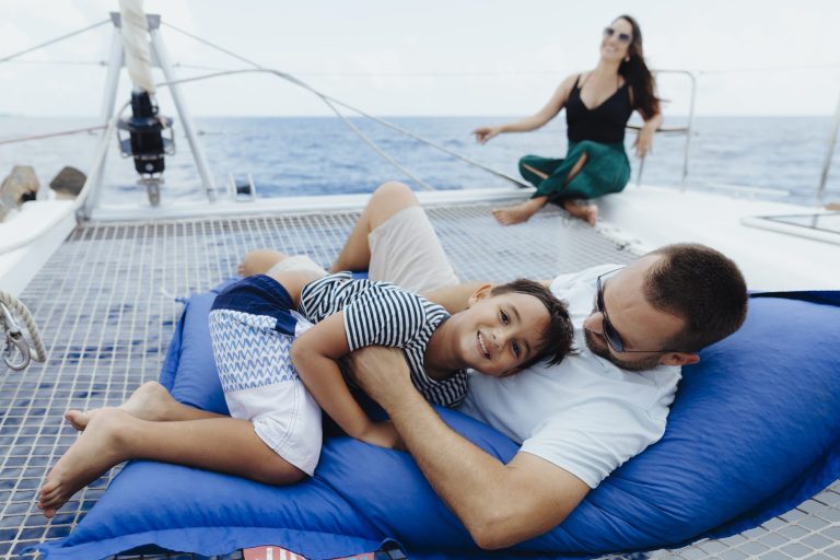 Family relaxing on the catamaran trampoline, Cozumel